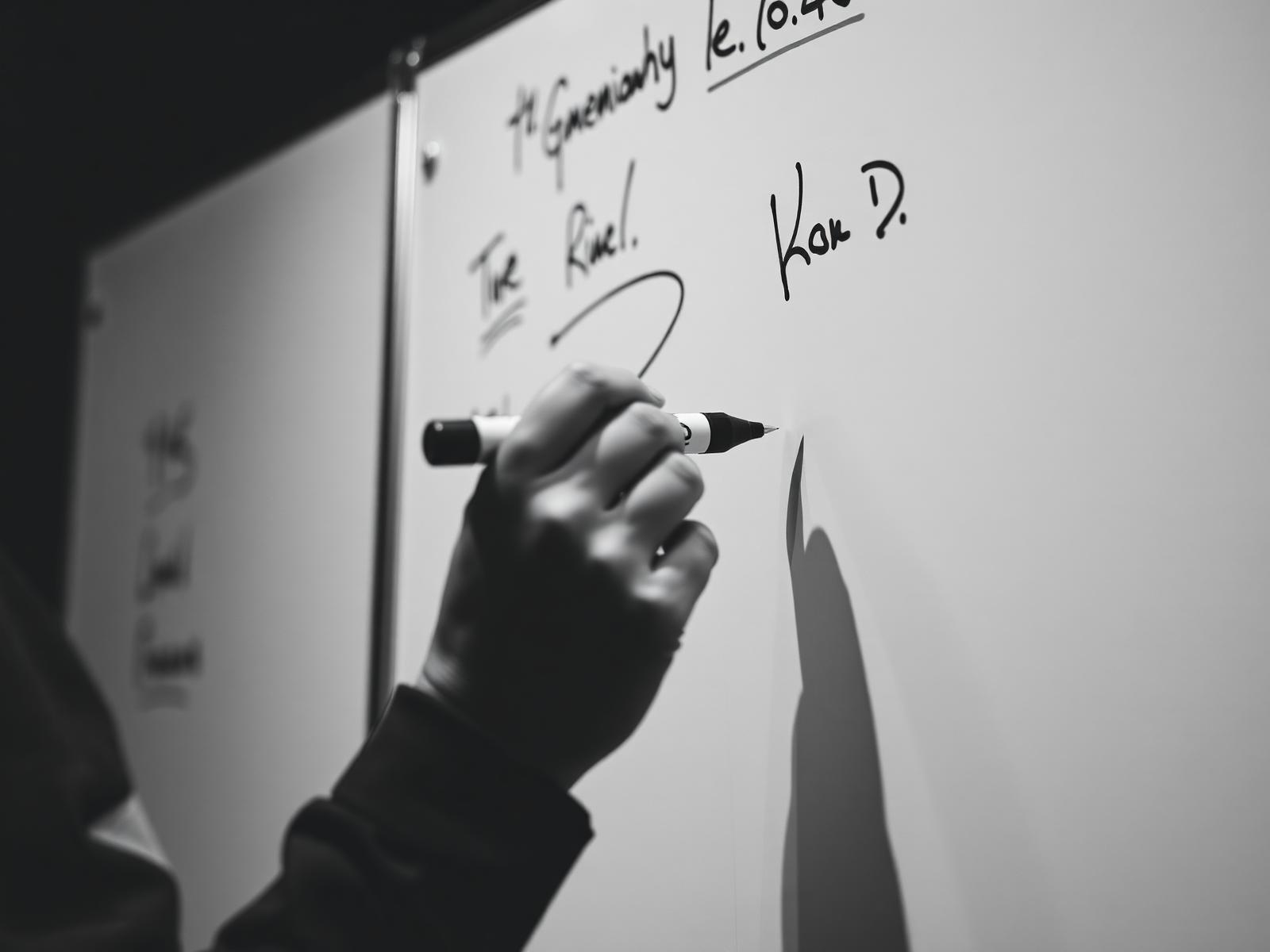Coach drawing plays on a whiteboard